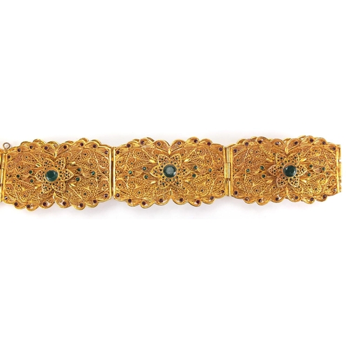 592 - Persian gilt metal filigree wedding belt, set with green and red faceted cabochons, 108cm in length