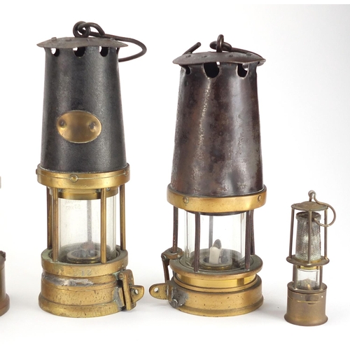 87 - Nine miners lamps including two Eccles, Oldham Type and J H Naylor, various impressed marks, the lar... 