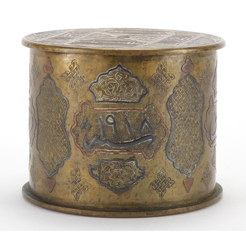 584 - Early 20th century Cairoware cylindrical brass pot and cover with silver inlay, decorated with scrip... 