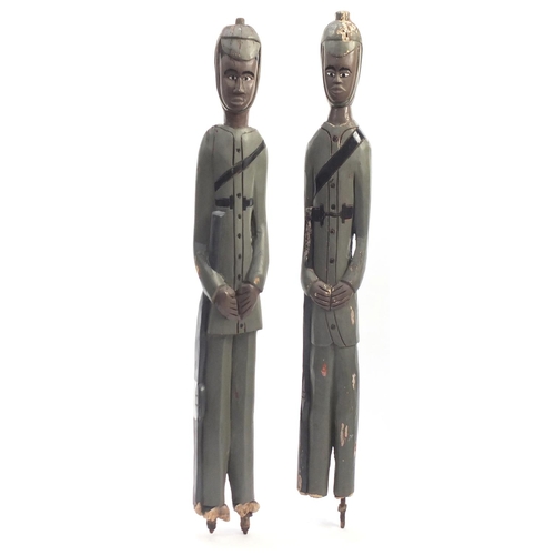 610 - Large pair of West African hand painted Colon figures, the largest 115cm high