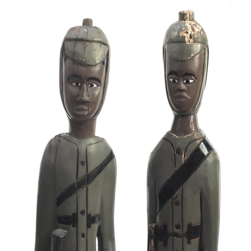 610 - Large pair of West African hand painted Colon figures, the largest 115cm high