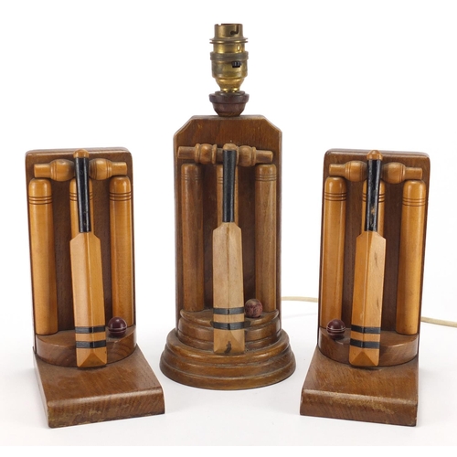 61 - Art Deco cricket design oak bookends and lamp, by Thornton Smith, one with inscribed paper label, th... 