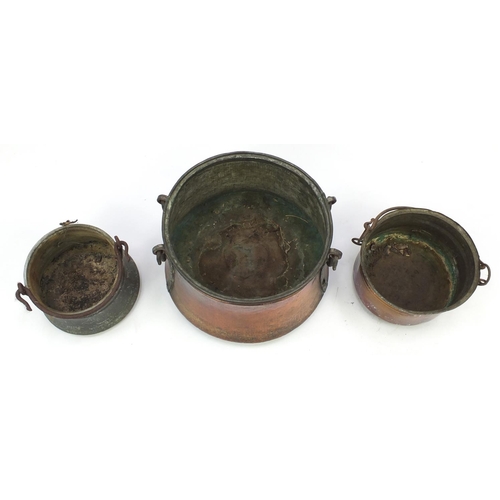 2132 - Three copper and brass cauldrons with swing handles, the largest 42cm in diameter