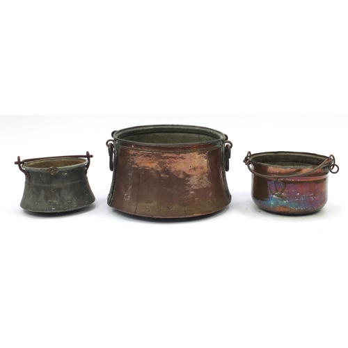 2132 - Three copper and brass cauldrons with swing handles, the largest 42cm in diameter