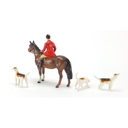 2417 - Beswick huntsman on horseback, with three hounds, the largest 21cm high