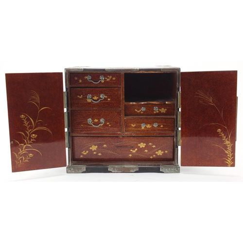 2161 - Japanese lacquer and gold dusted table cabinet, with a pair of doors opening to reveal an arrangemen... 