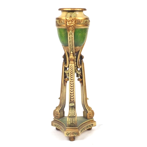 2055 - Classical cream and gilt carved wooden urn planter with face masks and tripod base, 107.5cm high