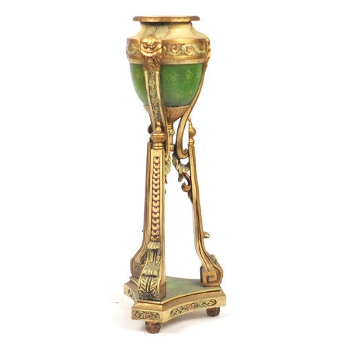 2055 - Classical cream and gilt carved wooden urn planter with face masks and tripod base, 107.5cm high
