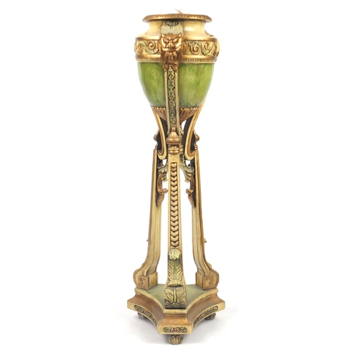 2015 - Classical cream and gilt carved wooden urn planter with face masks and tripod base, 121.5cm high