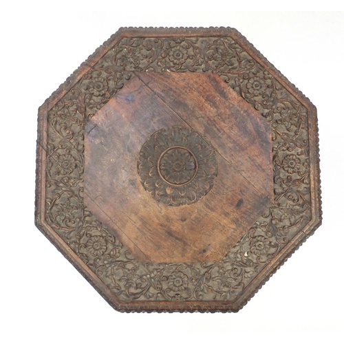 2076 - Indian hardwood octagonal folding table profusely carved and pierced with flowers, 56.5cm high x 55c... 