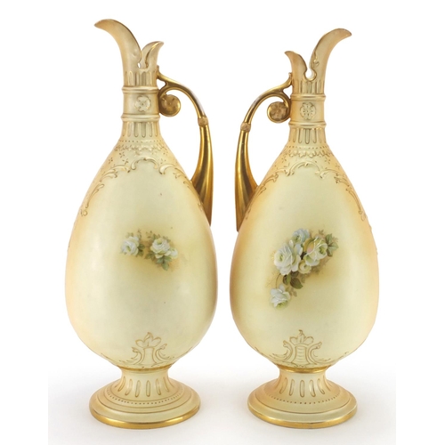 2230 - Large pair of Royal Worcester style blush ivory porcelain ewers, each gilded and decorated with flow... 