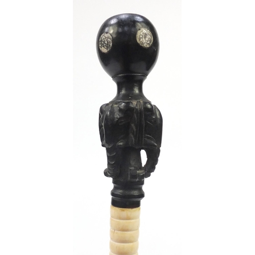 2498 - Segmented bone walking stick, with ebonised elephant head design pommel, the shaft decorated with fi... 