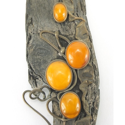 2517 - Modernist silver driftwood plaque, set with four butterscotch amber coloured cabochons, 25cm x 6cm