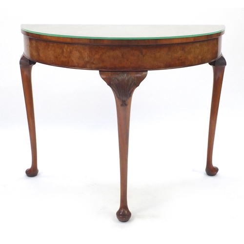 2042 - Burr walnut demilune side table, raised on cabriole legs carved with shells, 76cm H x 94cm W x 45cm ... 