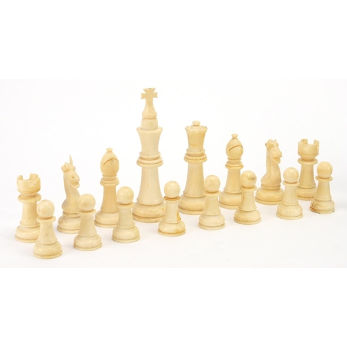 657 - Part stained turned and carved ivory chess set, the largest piece 9cm high