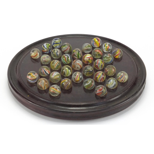 649 - Victorian solitaire board with marbles and box, the board 30cm in diameter, each marble approximatel... 