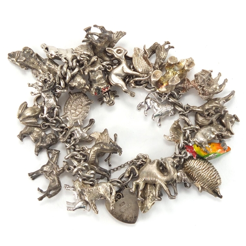 2705 - Heavy silver charm bracelet, with a large selection of animal charms, approximate weight 111.5g