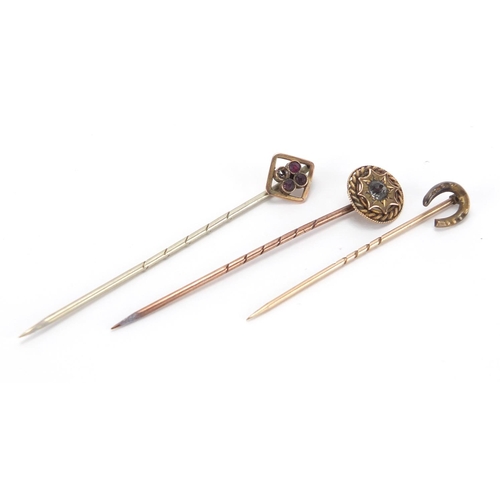 2721 - Three gold stick pins, one set with a solitaire diamond, approximate weight 2.5g