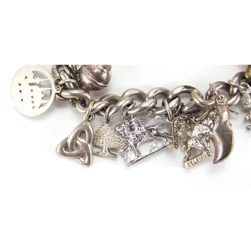 2724 - Silver charm bracelet with a selection of  charms, approximate weight 65.0g