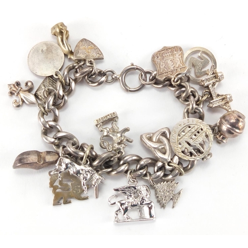 2724 - Silver charm bracelet with a selection of  charms, approximate weight 65.0g