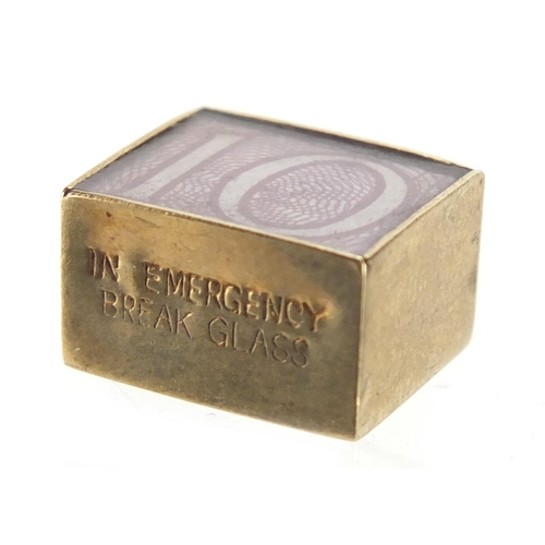 2760 - 9ct gold emergency ten shilling note charm, 1.5cm in length, approximate weight 2.5g