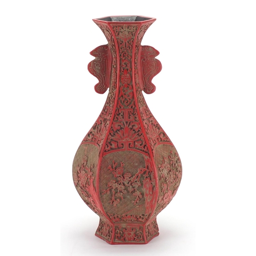 2166 - Chinese Cinnabar lacquer hexagonal vase, with twin handles carved with flowers, four figure characte... 