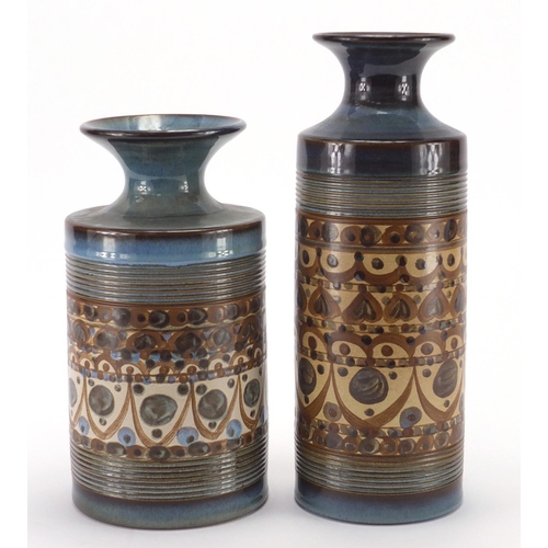 2327 - Two Denby cylindrical vases, by Audrey Cole Parker, each hand painted with stylised motifs, the larg... 