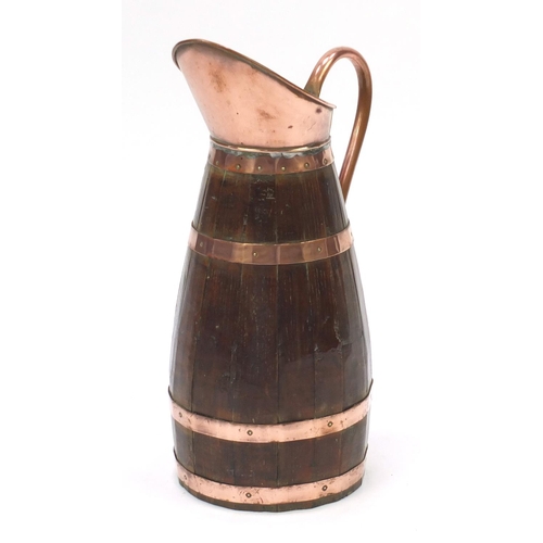 72 - Large oak and copper pitcher, 62cm high