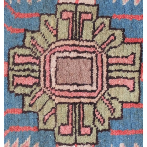 647 - Persian Serapi rug, having an all over stylised floral disign onto a red and blue ground, 260cm x 15... 