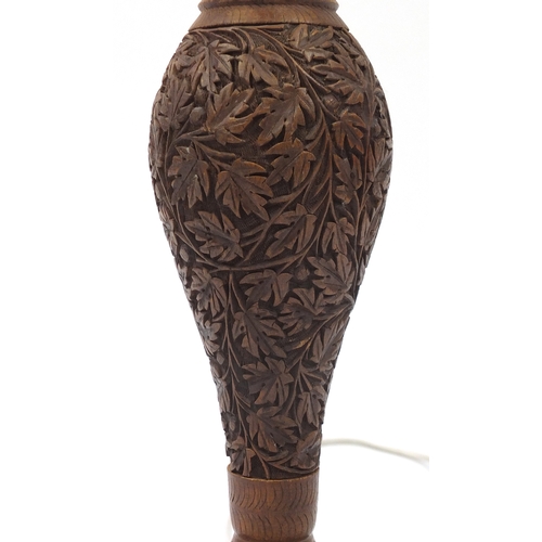 2077 - Indian Hardwood standard lamp, profusely carved with scrolling foliage, 160cm high