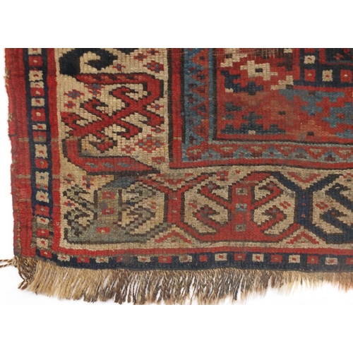 2064 - Rectangular Middle Eastern rug having an all over stylised geometric design within corresponding boa... 