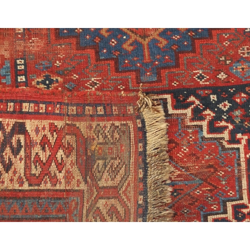 2064 - Rectangular Middle Eastern rug having an all over stylised geometric design within corresponding boa... 