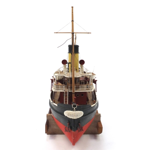 110 - Scratch built model boat on wooden stand, 48cm high x 79cm in length