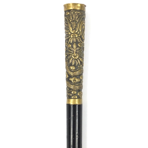 105 - Black painted metal swordstick with brass handle embossed with a Chinese dragon, 89.5cm in length