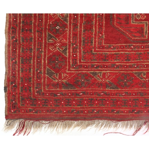 6 - Red ground rug, with all over geometric design, 170cm x 115cm
