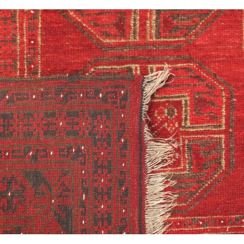 6 - Red ground rug, with all over geometric design, 170cm x 115cm