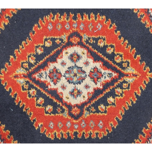 26 - Rectangular rug with all over geometric design, 128cm x 67cm