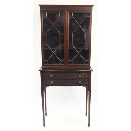 2012 - Mahogany bookcase on stand, with astragal glazed doors above two bow fronted drawers with blind fret... 