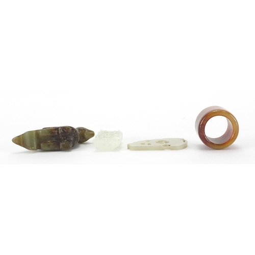 2522 - Chinese jade carvings including a mythical animal, thumb ring and a pendant carved with a dragon, th... 