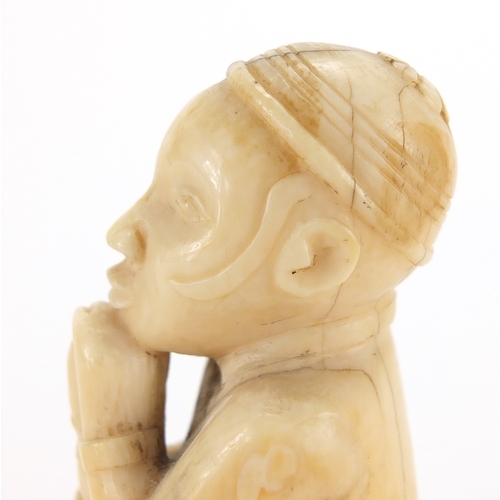 609a - Good African ivory carving of a tribesman holding a club, 10cm high