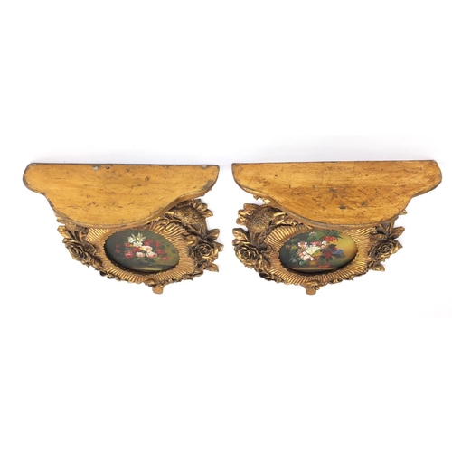 2081 - Pair of gilt wall brackets each having a circular panel hand painted with flowers, each 50cm