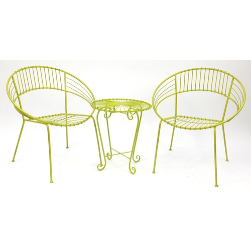 34 - Pair of green painted metal tub chairs and table