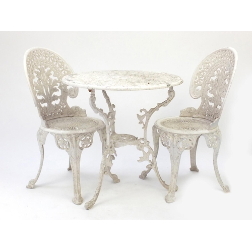 15 - White painted wrought iron garden table and two chairs