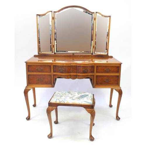 24 - Walnut dressing table, with mirrored back and a pair of matching bedside cupboards