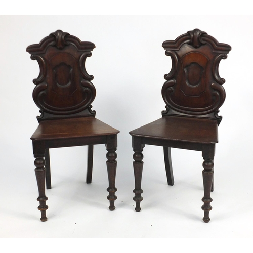 17 - Pair of Victorian carved mahogany shield back hall chairs, 89cm high