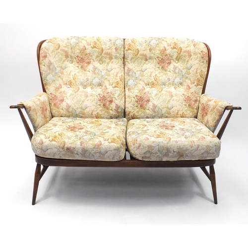 10A - Ercol elm stick back two seater settee, with floral upholstery, 140cm wide