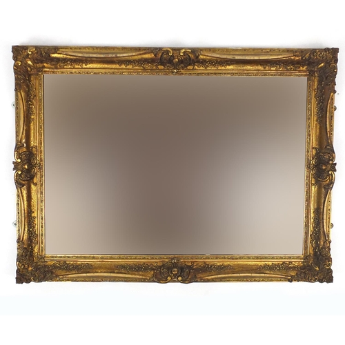 45 - Ornate gilt framed bevelled edge mirror,with peach glass, 101cm x 73.5cm