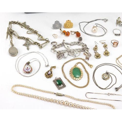 2466 - Costume jewellery including a 9ct gold necklace, silver charm bracelet with charms, butterscotch amb... 