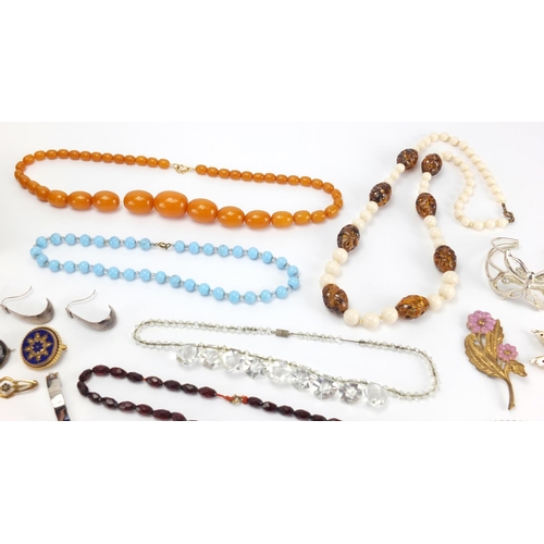 2466 - Costume jewellery including a 9ct gold necklace, silver charm bracelet with charms, butterscotch amb... 