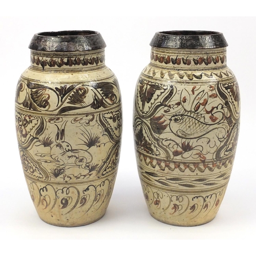 2018 - Two large Persian pottery jars, each hand painted with floral motifs, the largest 57.5cm high